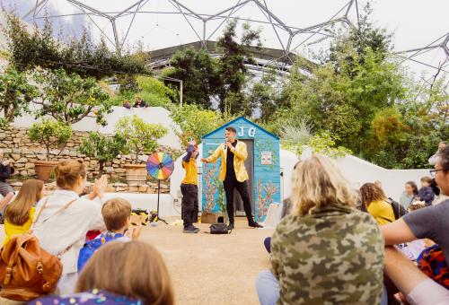 Skinny Jean Gardener performing show to audience in the Med Biome at The Eden Project
